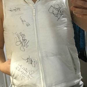 White puffer vest signed by Olympic gymnasts